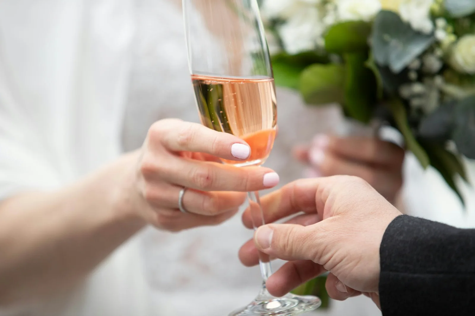 Two guests raising glasses at a celebration